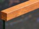 Woodgrain Aluminum Top Cap Seated On A Laminated Glass Railing Panel, Machined End Cap Visible